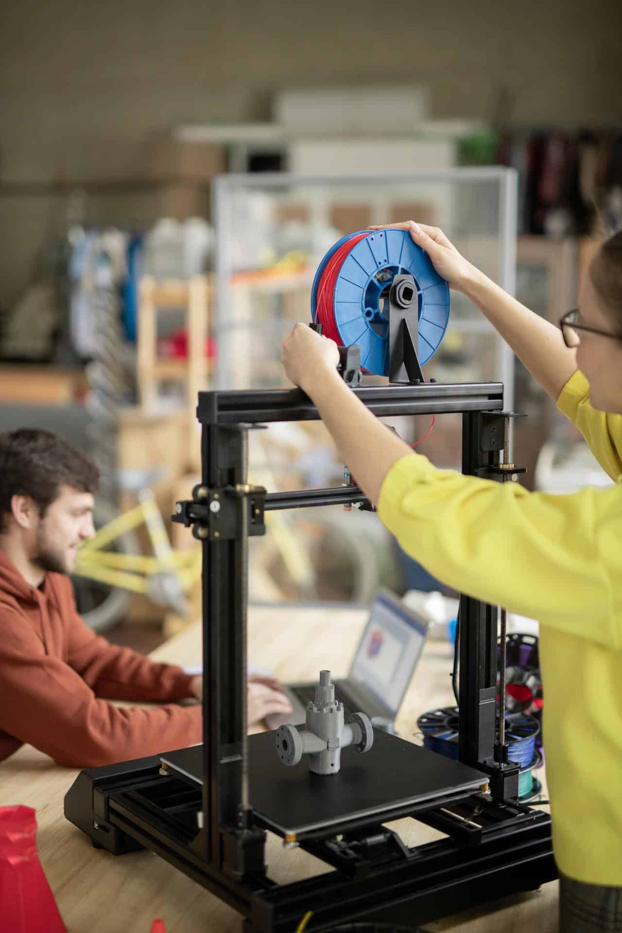 young woman putting new spool with filament on 3d 2021 09 24 03 08 11 utc